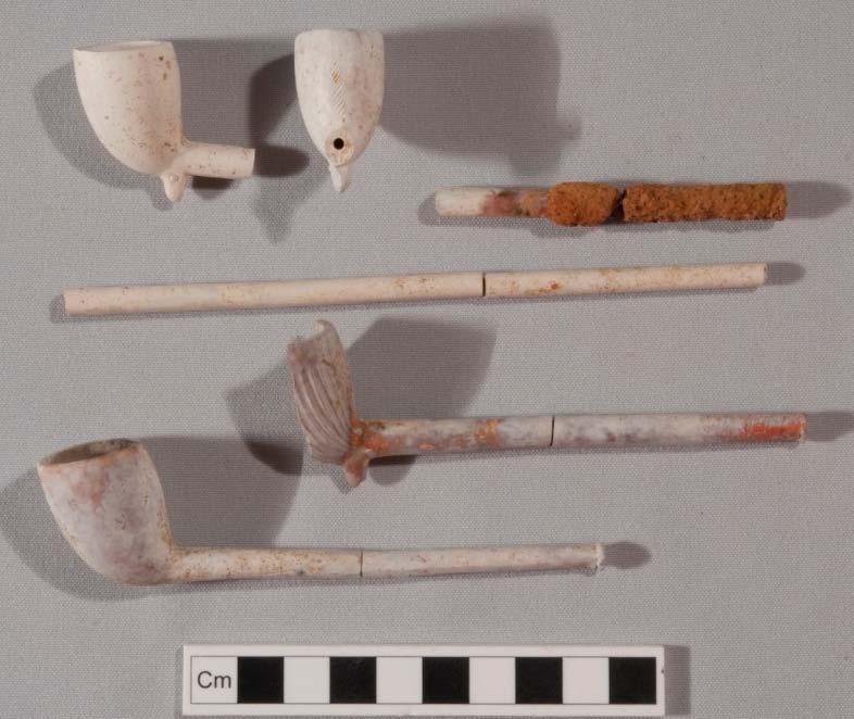 337 Figure 5.65: Selection of other Barth pipes from Area C underfloor deposit. Front row: complete plain 7444/#98075. Second row: near whole Fluted with red wax on mouthpiece 7444/#98196.