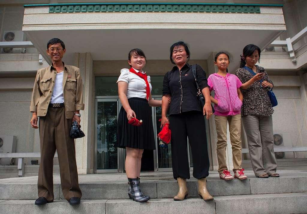 An upper class family leaving an expensive restaurant in Pyongyang.