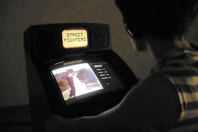 STREET FIGHTERS 2010 [Interactive game cabinet with touchscreen and electric wires, 8 videos] Street Fighters addresses the delicate theme of death at work in Italy, the country with Europe s highest
