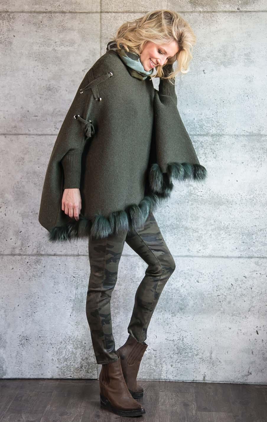 PONCHO with knit sleeves and fox trim.