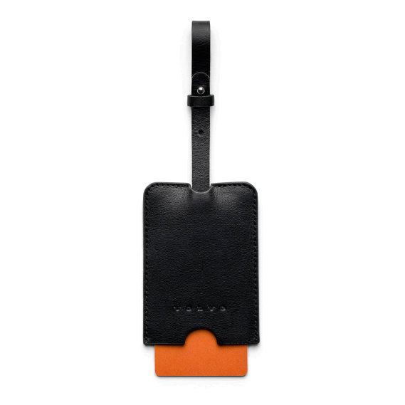 AUTUMN/WINTER COLLECTION Leather Luggage Tag Leather luggage tag with information card in orange secured by a leather strap.