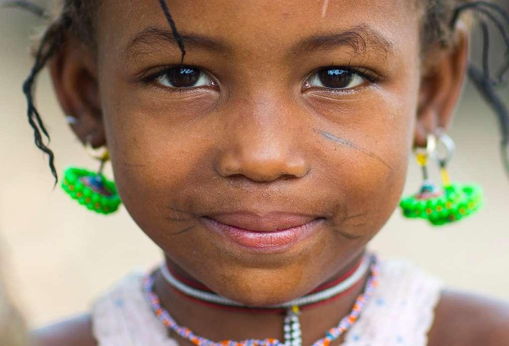 During a sort of Fulani baptism, a girl receives her first scars.