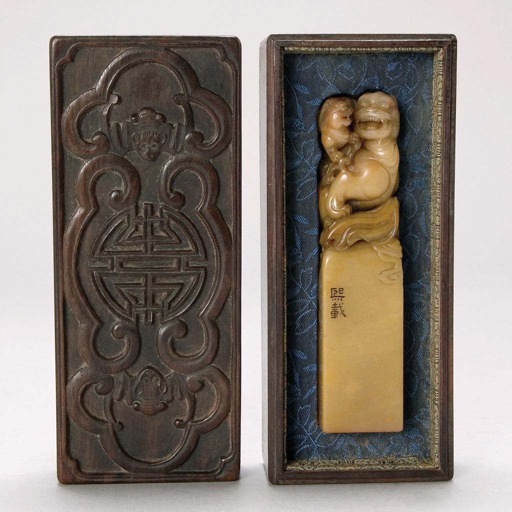 A Chinese Carved Soapstone Seal with Original Wood Box, signed by Wu Xi Zai, Qing Dynasty The seal depicts a detailed winged lion with cub, symbolic for happiness.