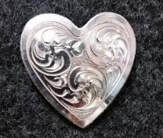 pin is a wonderful piece of jewelry that was hand engraved b y Leon Gage of Jordan
