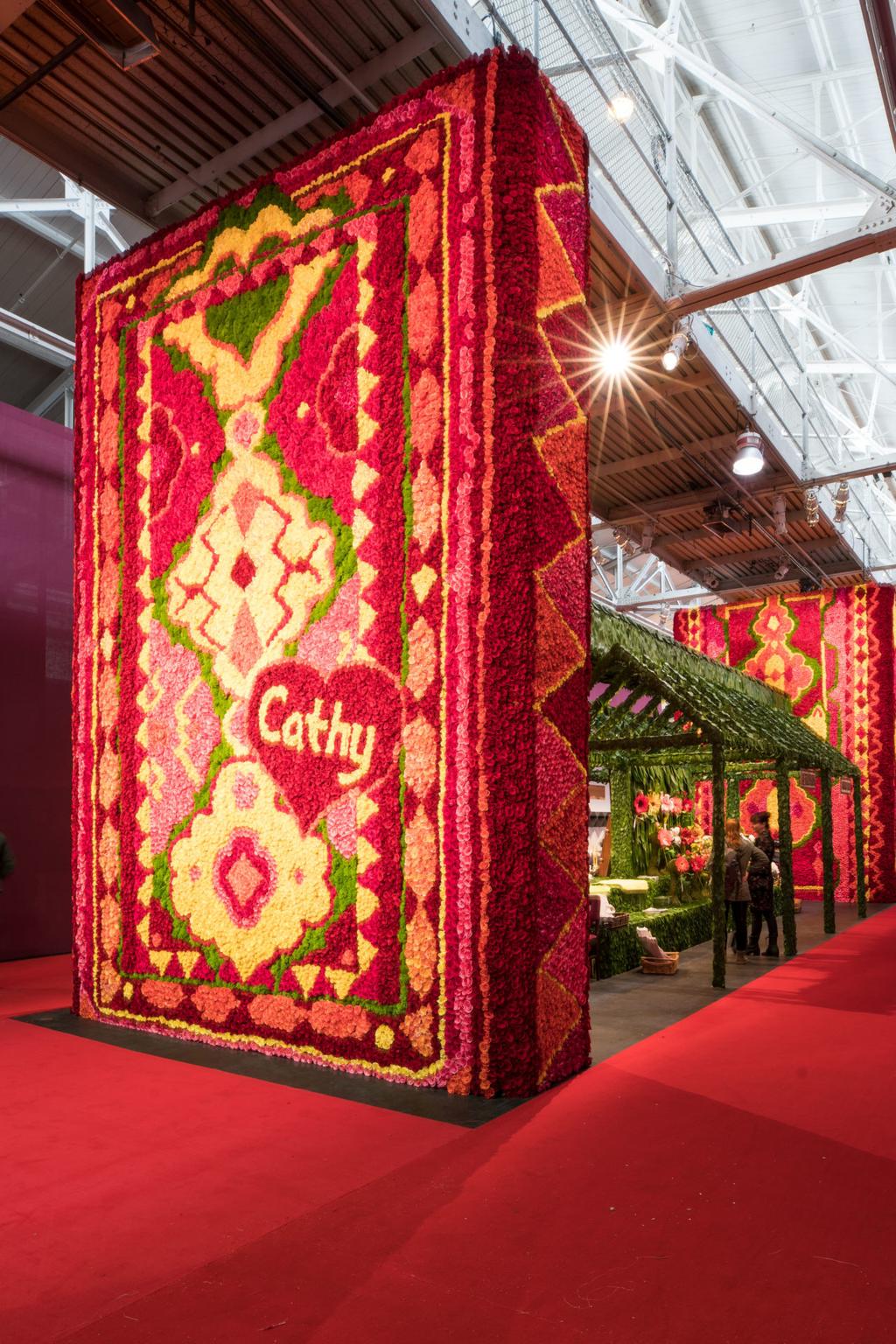 An enormous installation titled 21POP, comprised of vibrant rug patterns made from some 200,000 roses designed by San Francisco-based event planner Stanlee R.