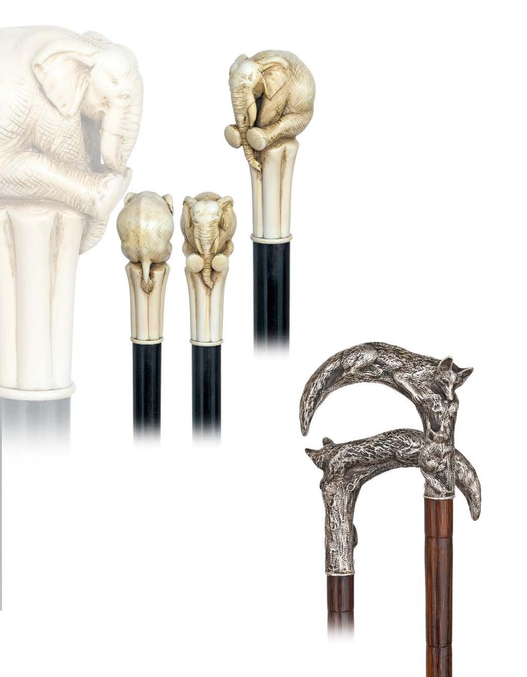 21 21. Great Ivory Elephant Cane English, 19th Century-An ivory circus elephant seated with a long trunk hanging between the front paws. Unusual fine detail to the face with tiny eyes, skin and tail.