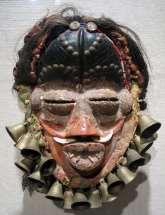 10 Liberian, probably Dan or We (Ngere) people Mask, 20th century wood, with traces of red tukula (camwood tree powder) and European pigments; brass tacks; buttons; tusks; human hair; fabric; and