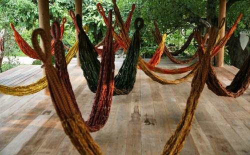 cotton Paa-Lai fabrics of the type that were included in the royal sponsored relief bags, Pinaree has constructed a group of woven hammocks that will be suspended in the gallery from slender threads.