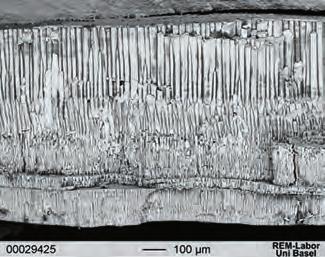 At higher magnification (center) the transition from columnar to tabular growth is plainly visible; the left side of the aragonite shows a more irregular growth pattern than the right side.