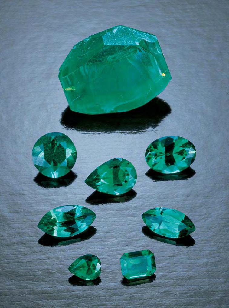 Figure 1. This 4.72 ct crystal (sample H) and the 0.13 0.61 ct faceted samples are some of the hydrothermal synthetic emeralds grown in China that were examined for this study.