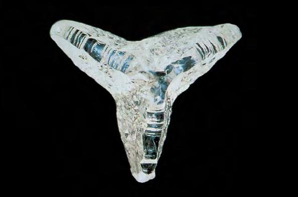 Figure 3. This 0.60 ct slightly etched natural cleavage of a cuboid diamond from the Jwaneng mine, Botswana, shows the skeletal appearance that is sometimes formed during cuboid diamond growth.