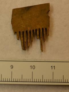 Decoration: - Type: - Description: A single comb tooth attached to a tooth plate. It has half a hole after a rivet.