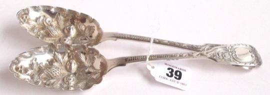 London silver berry spoons profusely embossed and having fiddle pattern handles by