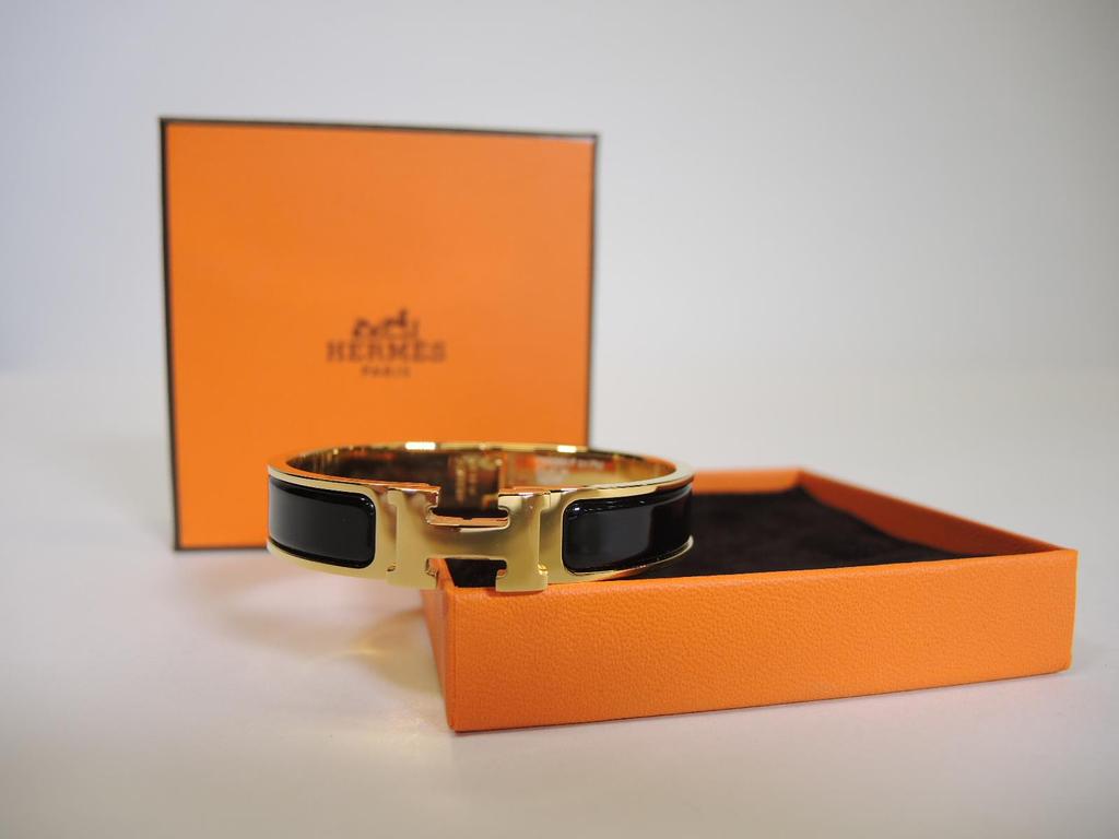 HERMÈS Black and Gold Click H Bracelet PM Retails for $600, sold in one day for $399.