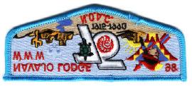 Has the National 75 th emblem in the center of the patch with the lodge totem in upper left hand side. The totem has black outline.
