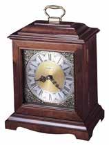 High gloss Windsor Cherry finish This arch top mantel clock urn clock includes a faux drawer front with polished