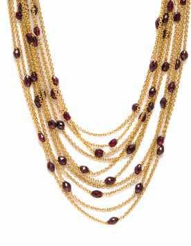 268 267 269 267* An 18 Karat Yellow Gold and Garnet Multi Strand Necklace, Scusi Paris, comprised of ten cable link chains accented at regular intervals with numerous faceted deep red garnet beads,