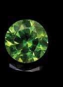 13 carats and measuring approximately 6.36 x 6.33 x 3.96 mm, together with one demantoid garnet weighing 1.03 carats and measuring approximately 6.12 x 6.07 x 3.92 mm.