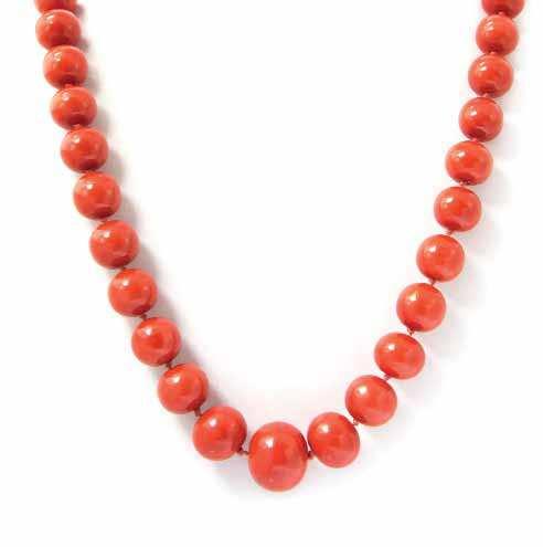 $2,000-3,000 418 An Impressive Graduated Single Strand Coral Bead Necklace, consisting of 64 near round to barrel shape reddish orange coral beads measuring approximately 9.54-20.