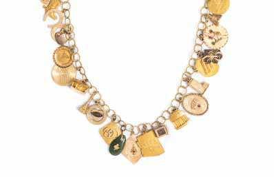 970 959 959 A 14 Karat Yellow Gold Charm Necklace with Numerous Attached Charms, including a 14 karat gold PS I Love You charm, a 14 karat gold Balinese charm, a MS Kungsholm ship charm, a 10 karat