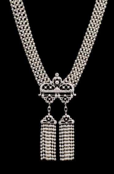 50 carats total, the pendants supporting nine strand fringes of seed pearls strung on platinum chain, the central section supported by a seven-row seed pearl and platinum chain link meshwork