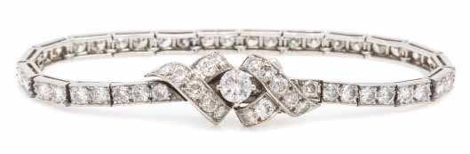 $4,000-6,000 139 A Vintage Platinum and Diamond Eternity Band, in an openwork two row design, containing seven baguette cut diamonds weighing approximately 0.