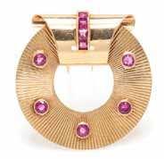 Property from a Private Collection $500-700 179* A Retro 14 Karat Rose Gold and Dress Clip, French, circular form with luted surface and containing ive bezel set round mixed cut rubies, surmounted at