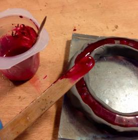 Pour a thin layer into the top of the mould, ensuring that it covers both the stripy and clear sections of cured resin.