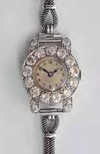 250-350 218 A lady's diamond mounted cocktail wristwatch, the circular dial in a platinum case within a surround of circular brilliant-cut diamonds and on a 9ct white gold mesh-link bracelet