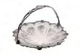 126 126 A Victorian swing-handled cake basket of circular form with flowerhead and scrolling foliate edge and pierced rim, the centre engraved with sprays of flowers, on scroll and foliate feet, 29cm