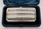 200-300 134 A Victorian cigar case of rectangular shape, inscribed, engraved with foliate scrollwork, containing five original Havana cigars, 12cm long,