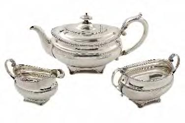 100-200 155 156 157 157 An Edwardian matched threepiece tea service of an oval form with gadrooned rims and swept handles with engraved bands to the