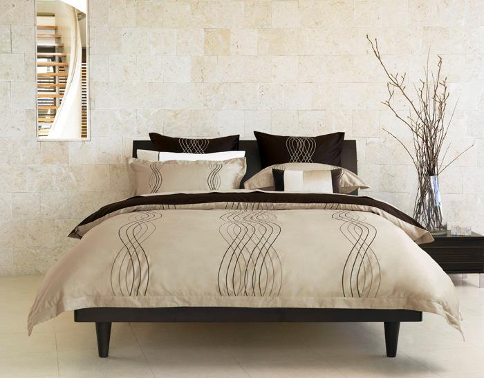 Mayan Organic waves of tonal colour are intricately embroidered to create this striking design.