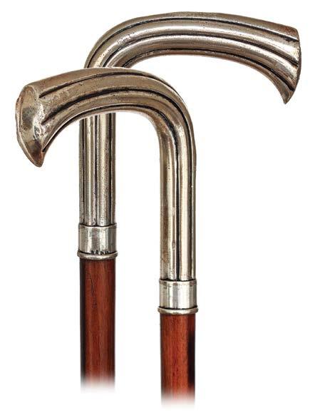 100. Decorative Day Cane Ca. 1900-Large silver plated handle fashioned in a basic L-shape with grooves gently expanding in a lotus flower-like shape, Makassar ebony shaft and a white metal ferrule.