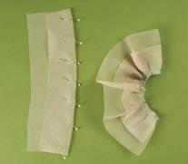 Follow the sleeve-cap cutting line to cut the organza into a shape that resembles a football when unfolded.