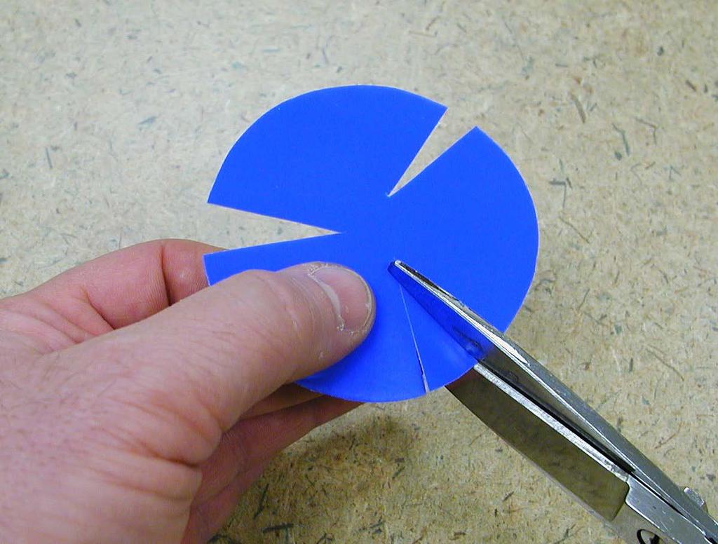 trim a standing fold with scissors (such as