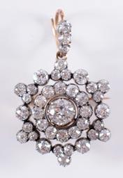 A late 19th century gold, silver and diamond mounted circular pendant with central round brilliant approximately 0.
