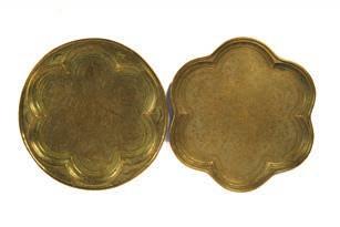 200 Two brass trays 19th Century, Persian one depicting six portrait heads of Shanama, the other of lobed design, with
