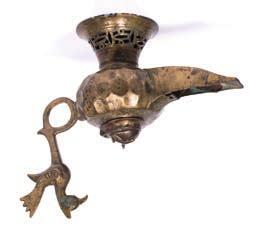 5cm high 271 Oil lamp Islamic of typical form, with a pierced cut work base, with bird finial on the handle 18cm across 500-800 (plus 24%BP*) 1000-2000