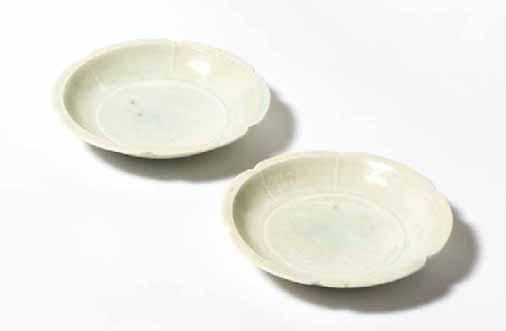84 51 51 A pair of Chinese Qingbai foliate dishes Northern Song dynasty, 11th-12th century a bluish white glaze, stopping short at the foot revealing the orange burnt buff. Diam. 9.