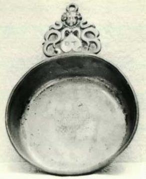 Item 443 A Charles II porringer with a single ear of the inverted S type, the top with a cherub and a small ring for hanging.