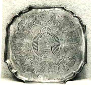 Item 455 An 18th century square salver with cut and shaped corners to make it octagonal. On feet lavishly engraved.