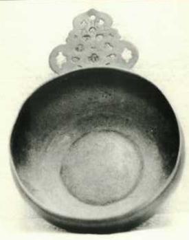 Item 465 A bulbous sided bumpy centre porringer with pierced ear and the touch of