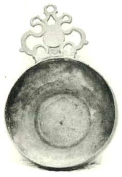 Item 468 A bulbous sided bumpy centred porringer with pierced ear and on the back the touch