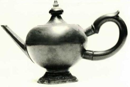 Item 497 A rare cricket-ball shaped body teapot and hexagonal spout and wooden handle set into Pewter sockets. The spring hinged lid has a wooden knop.