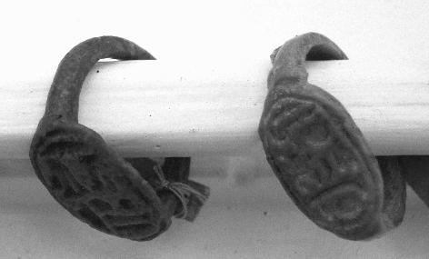 are given human heads, or rather faces, rudely and flatly cut. This human face is very characteristic of the Heart-scarabs of the later Middle Kingdom.
