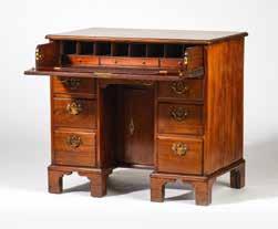 109 212 A Louis XV-style desk Circa 1900 The desk top lined with three blackened canvas panels, the edges mounted with bronze profiles, the corners with cast shell ornaments, the drawers with burr