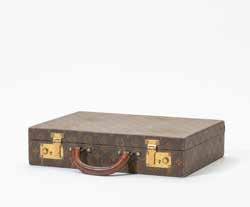 119 235 A Louis Vuitton hard suitcase Early 20th century Covered in LV fabric, the interior in leather, with brass locks. H. 28.2 x W.39 x D.