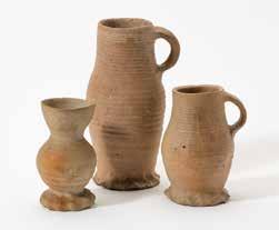 122 247 A collection of three various Siegburg jugs Germany, 15th century Two with concentrical body cordons and a single handle, one with an extended edge and concentrical
