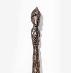 369 A large Humbolt-bay wood peddle with figure-carved end New Guinea, circa 1900 One side of the blade finely carved with a saw-fish, and hammer-head sharks, the other side with the latter, to a